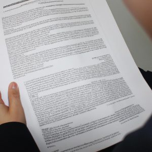 Person holding paperwork, reading documents